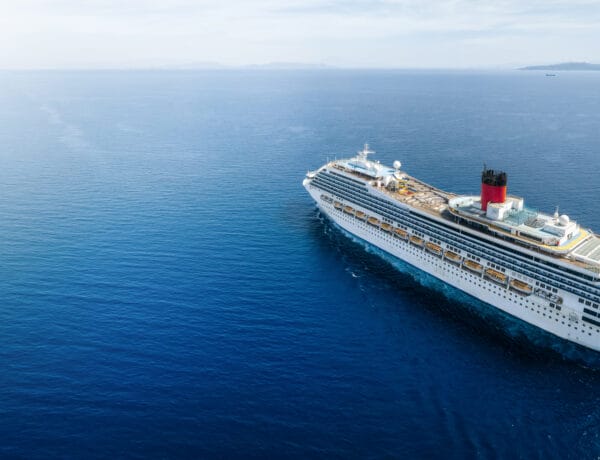 Concept for vacation and travel with a cruise ship sailing over the ocean with copy space