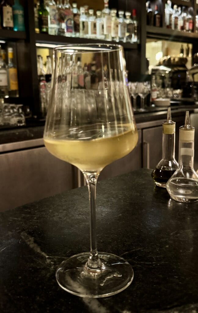Wine glass with white wine at Dalida