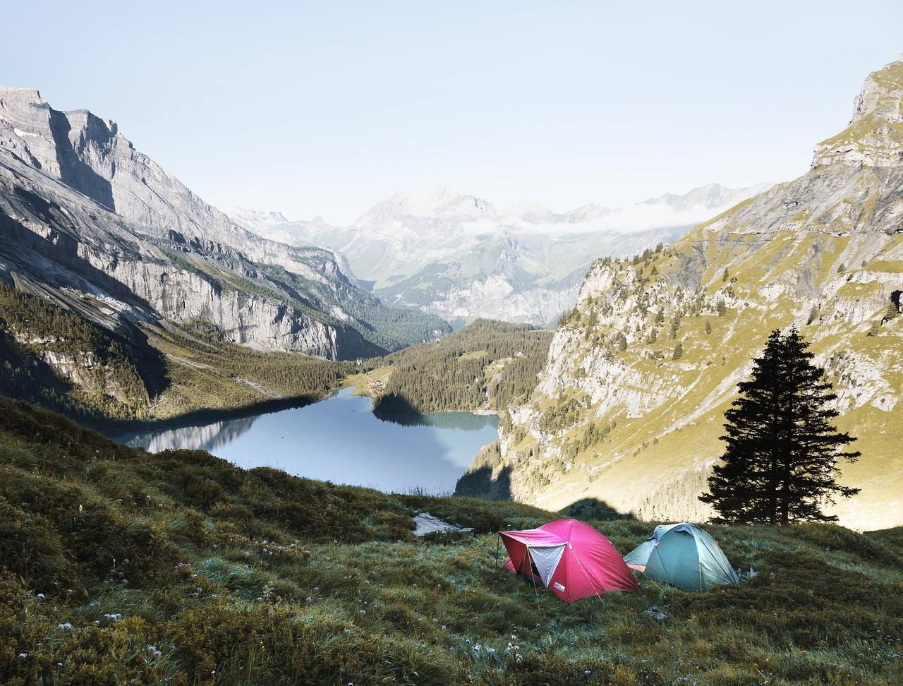 Camping, with tents and mountains in the backdrop