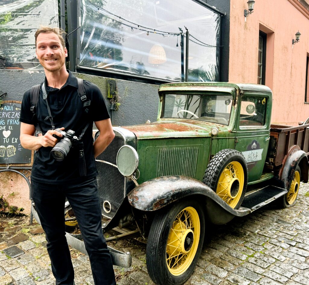 Ryan with an old vintage car in Colonia del Sacramento