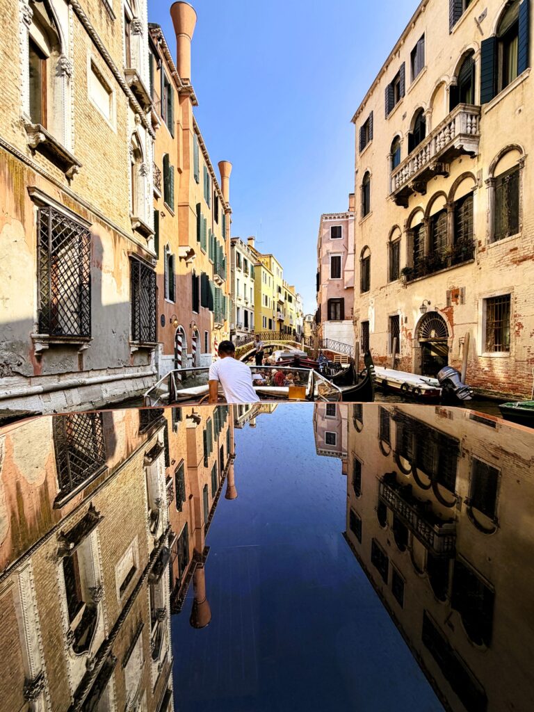 Water taxi with reflection of city on its roof